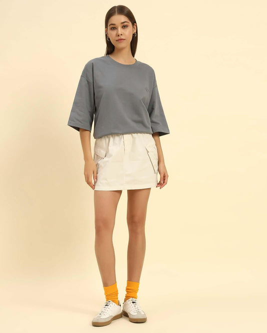Oversized French terry t-shirt for women in dark grey, paired with a white skirt and yellow socks.