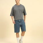 Model wearing the Dark Grey Aeternum French Terry Crew Neck styled with shorts - Men's relaxed summer streetwear.