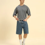 Lifestyle view of the Men's Dark Grey Oversized French Terry T-Shirt, demonstrating the shirt's effortless drape and style.