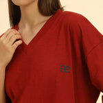 Close-up of the V-neckline and textured cotton slub fabric on the Aeternum Women's Red T-Shirt.