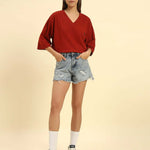 Model wearing the Red Aeternum Cotton Slub T-Shirt styled with denim shorts - Women's casual oversized fit