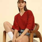 Lifestyle view of the Red Aeternum Women's Cotton Slub T-Shirt showing a comfortable, relaxed aesthetic