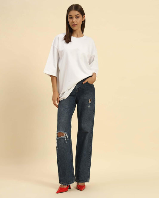 AE Oversized French Terry Crew Neck T-Shirt | White | Woman styled with distressed jeans and red heels.