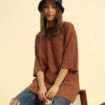 Oversized Waffle Knit Round Neck T-Shirt | Coffee Brown | Woman worn by young woman sitting on a chair.
