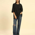 Model wearing the Dark Green Aeternum Jacquard T-Shirt styled with denim jeans - Women's casual oversized streetwear look