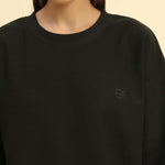 Close-up of the round neckline and intricate jacquard knit pattern on the Aeternum Women's Dark Green T-Shirt