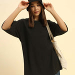 Lifestyle view of the Women's Aeternum Oversized Jacquard T-Shirt in Dark Green showing a comfortable, relaxed fit.