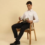 Model seated wearing the Aeternum Men's Classic Fit Supima Cotton Shirt, showcasing the shirt's versatility and professional aesthetic.