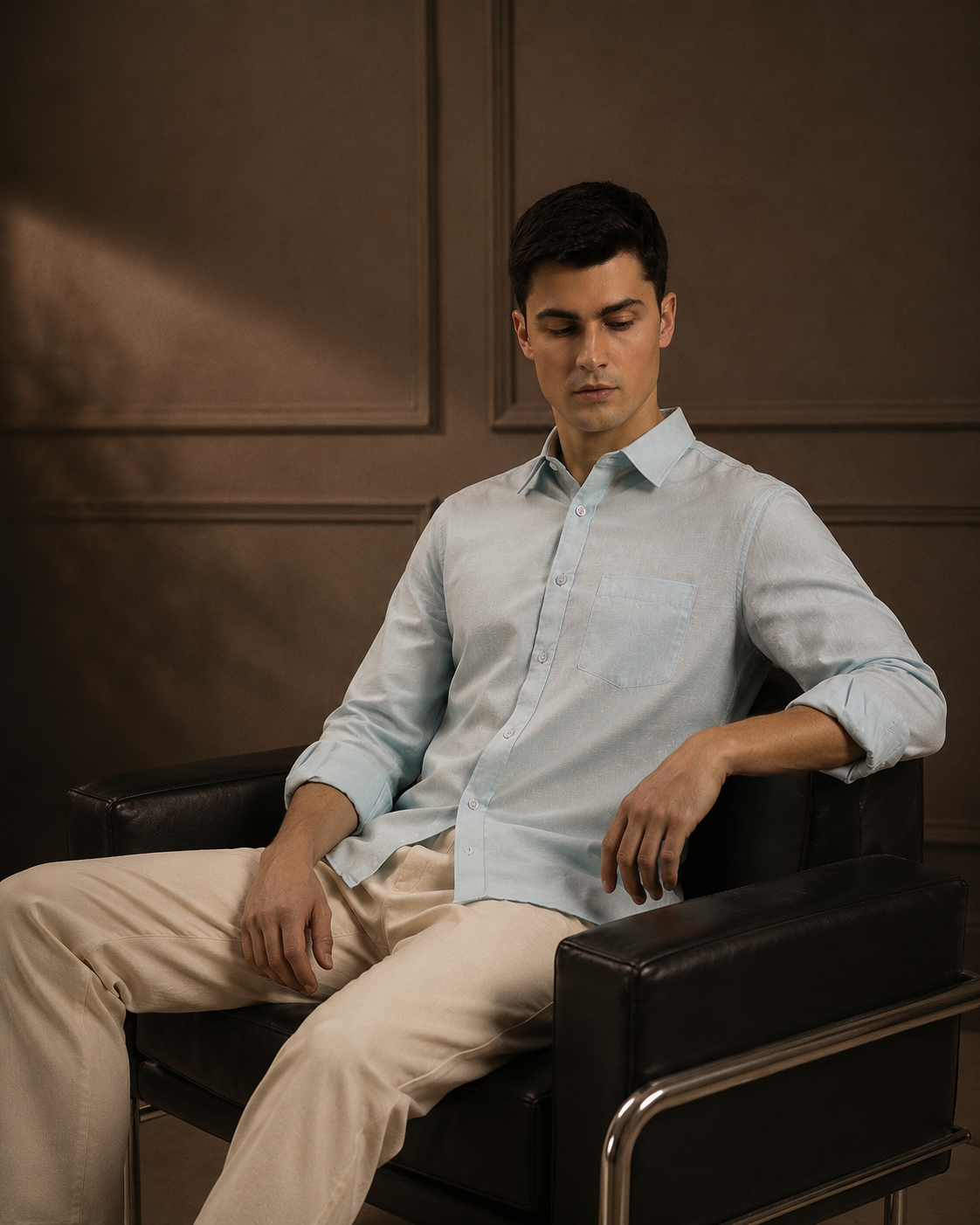 Man wearing a light blue shirt from the collection of men's linen shirts, showcasing comfort and style.