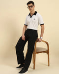 Model seated wearing the White Aeternum Premium Cotton Polo, showcasing the shirt's versatility and comfort.