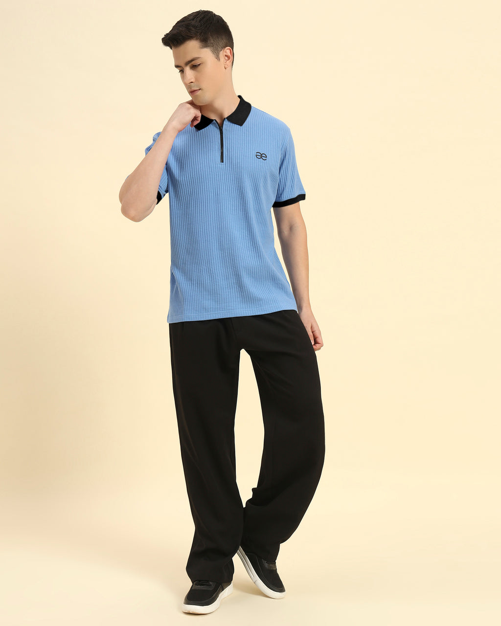 Model wearing the Sky Blue Premium Classic Fit Rib Knit Polo styled with dark trousers - Men's sophisticated casual look.