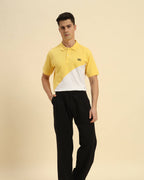 Model wearing the Yellow & White Premium Classic Fit Cotton Polo styled with dark trousers - Men's casual athletic look.