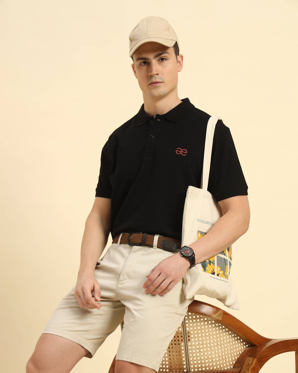 Full body view of the Black Aeternum Cotton Polo styled with light-colored shorts for a classic summer aesthetic.