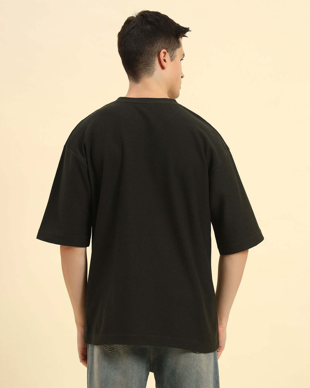 Back view of the Aeternum Men's Oversized Jacquard T-Shirt in Dark Green, demonstrating the clean and loose fit.