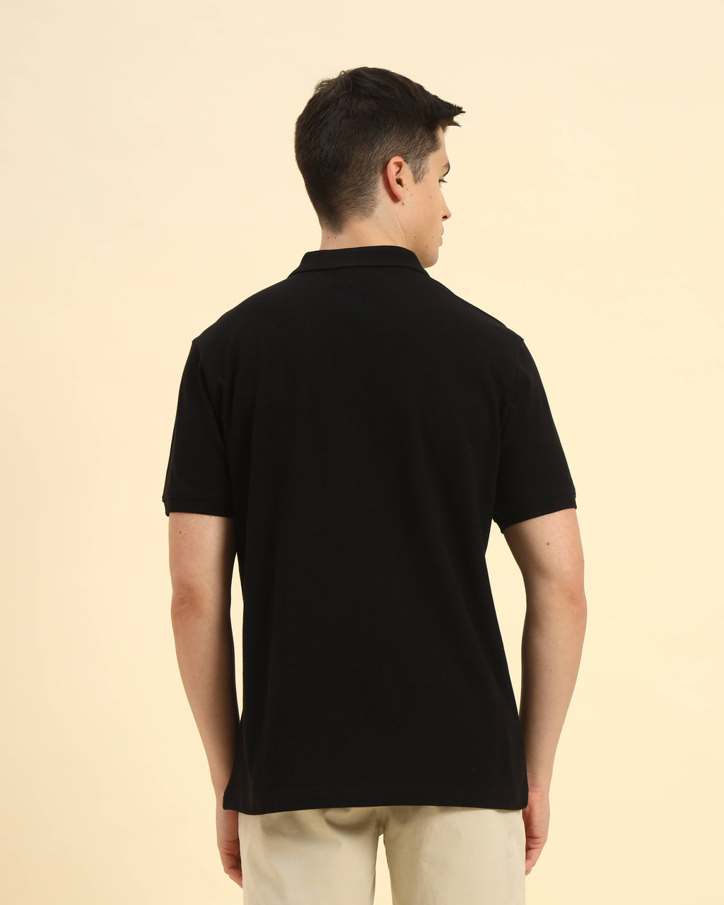 Back view of the Aeternum Men's Black Cotton Polo highlighting the clean, classic shoulder construction