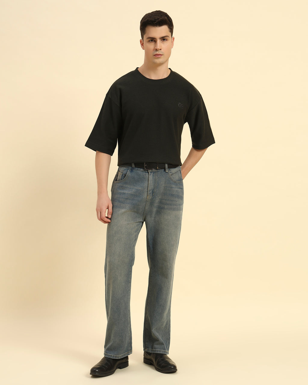 Model wearing the Dark Green Aeternum Jacquard T-Shirt styled with grey trousers - Men's sophisticated casual look