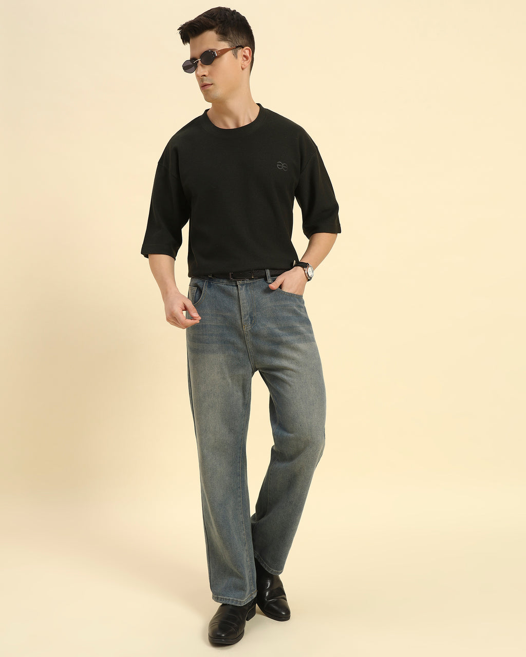 Lifestyle view of the Aeternum Men's Oversized Jacquard Round Neck T-Shirt in Dark Green, showcasing movement and comfort.