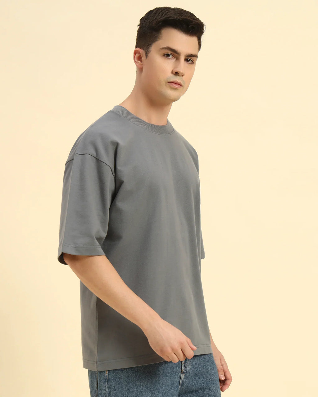 Three-quarter profile of the Men's Dark Grey Aeternum French Terry T-Shirt highlighting the soft, textured knit.