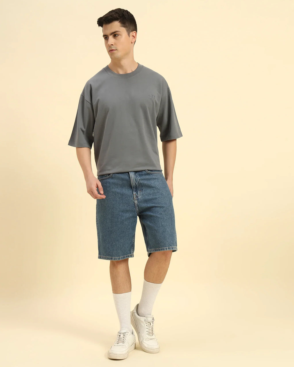 Model wearing the Dark Grey Aeternum French Terry Crew Neck styled with shorts - Men's relaxed summer streetwear.