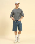 Lifestyle view of the Men's Dark Grey Oversized French Terry T-Shirt, demonstrating the shirt's effortless drape and style.
