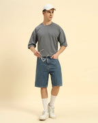 Lifestyle view of the Men's Dark Grey Oversized French Terry T-Shirt, demonstrating the shirt's effortless drape and style.