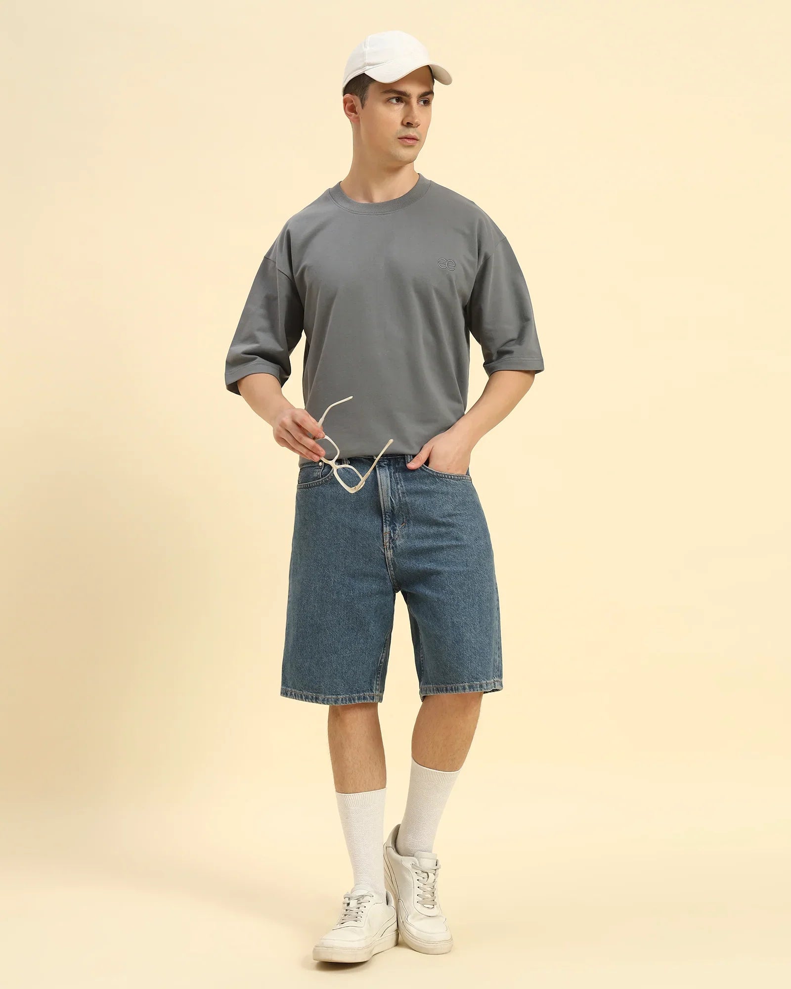 Lifestyle view of the Men's Dark Grey Oversized French Terry T-Shirt, demonstrating the shirt's effortless drape and style.