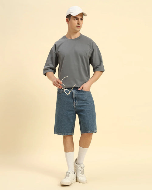 Lifestyle view of the Men's Dark Grey Oversized French Terry T-Shirt, demonstrating the shirt's effortless drape and style.