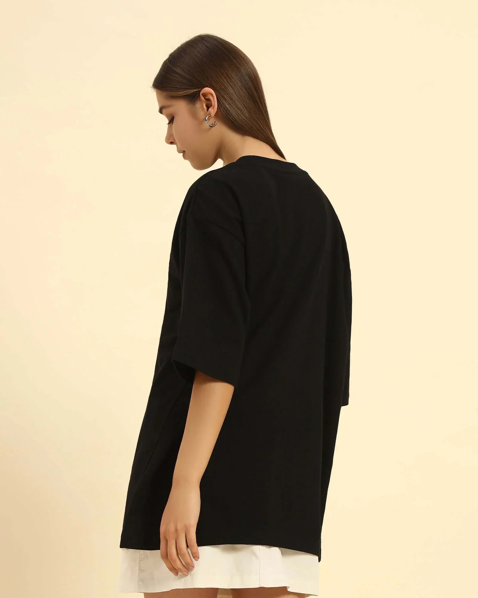 Side profile of the Aeternum Women's Oversized T-Shirt in Black, highlighting the heavyweight cotton drape.