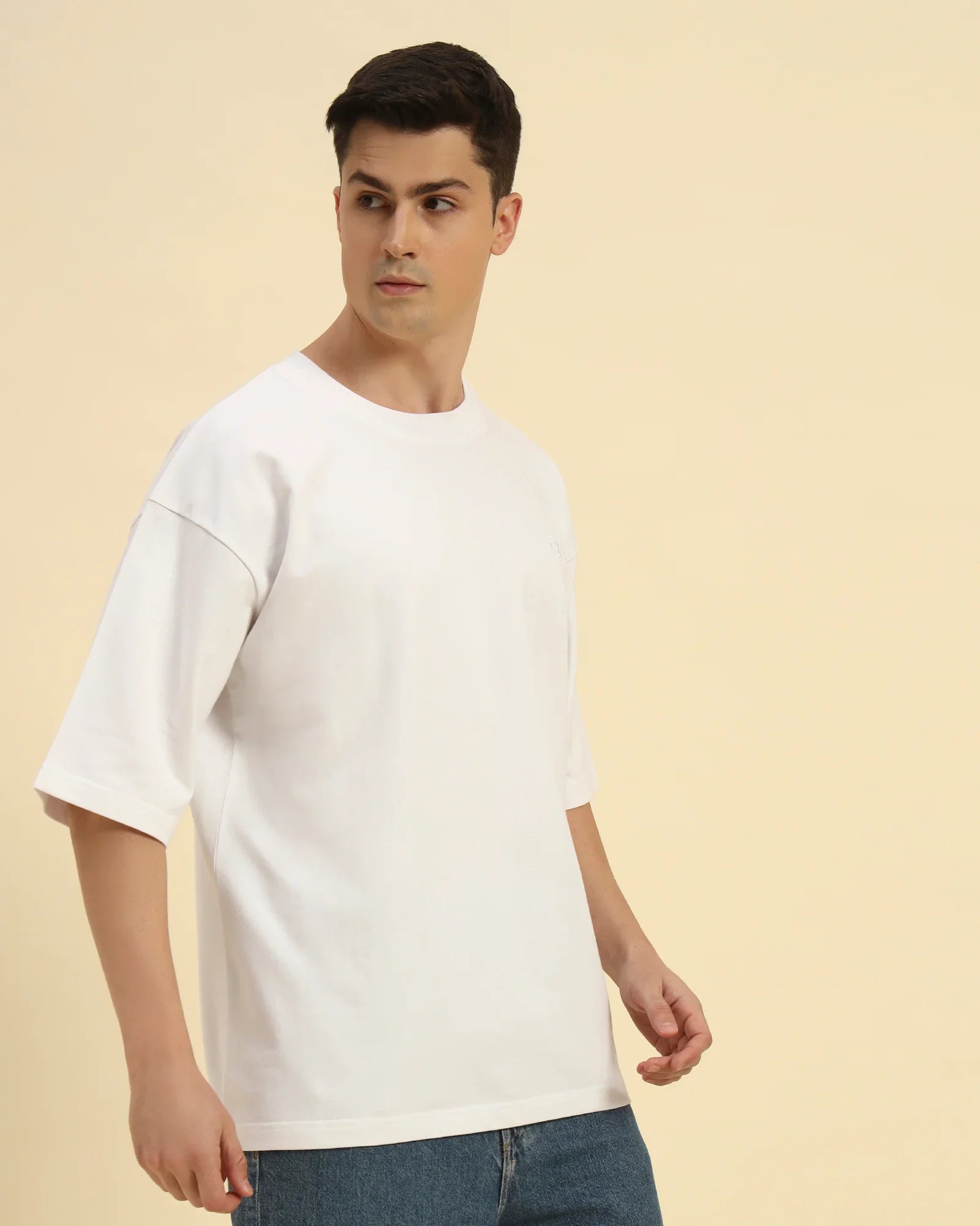 Three-quarter profile of the Men's White Aeternum French Terry T-Shirt highlighting the relaxed fit and soft drape.