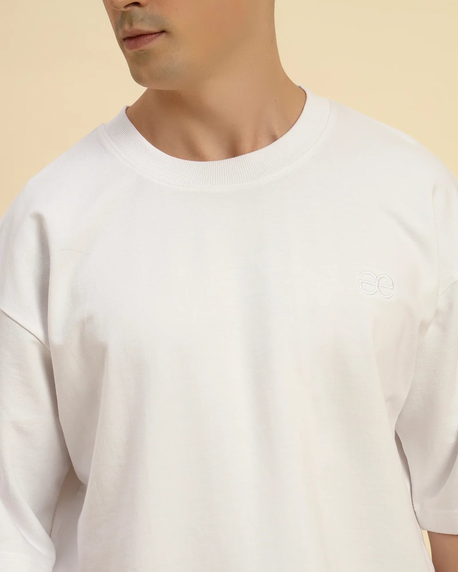 Close-up of the ribbed crew neckline and premium French terry knit on the Aeternum Men's White T-Shirt.