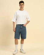 Model wearing the White Aeternum French Terry Crew Neck styled with denim shorts - Men's casual summer streetwear.