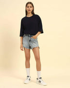 Model wearing the Navy Blue Aeternum French Terry T-Shirt styled with denim shorts - Women's casual oversized look