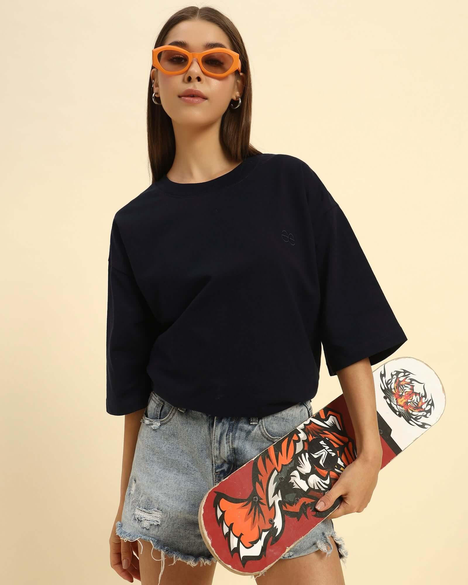 Lifestyle view of the Women's Aeternum Oversized French Terry T-Shirt in Navy Blue showing a comfortable, relaxed fit