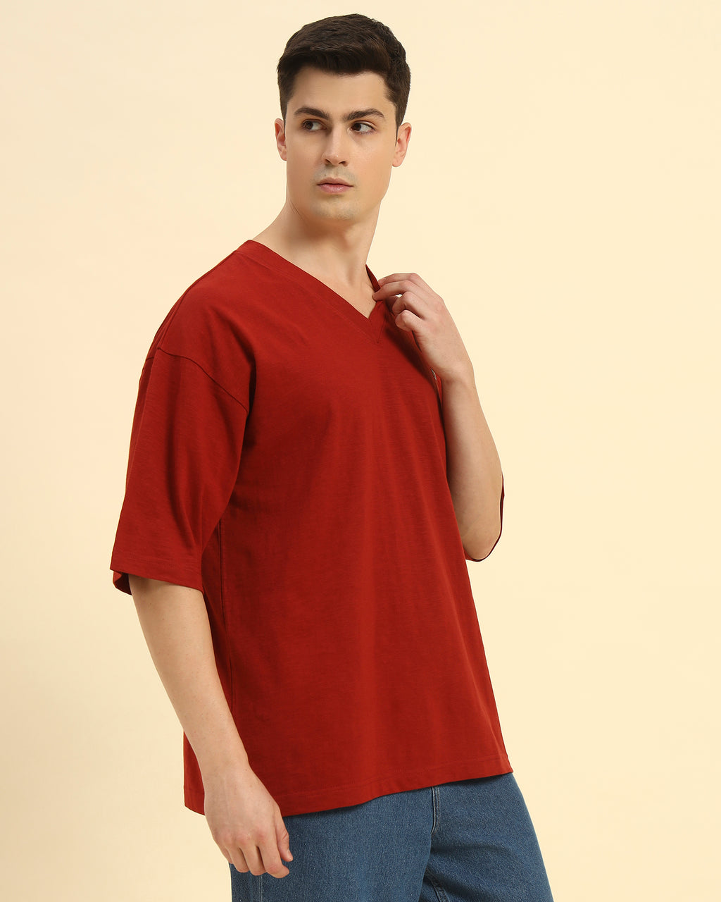 Three-quarter profile of the Men's Red Aeternum Cotton Slub T-Shirt highlighting the casual drape and v-neckline.