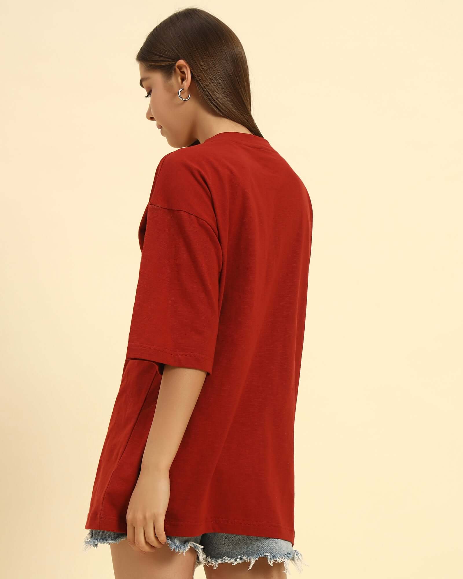 Side profile of the Red Oversized Cotton Slub V-Neck T-Shirt highlighting the loose silhouette and lightweight fabric