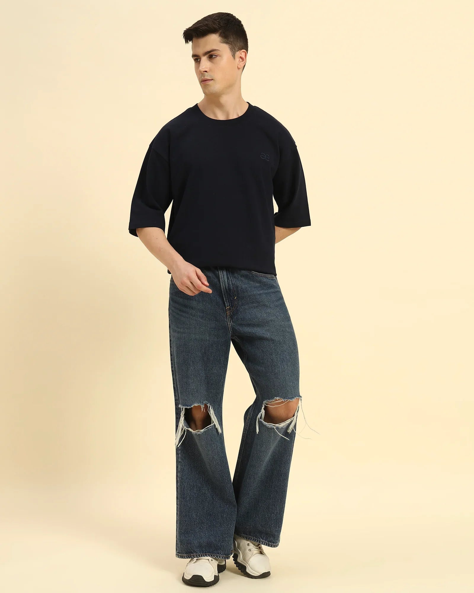 Full body view of the Navy Blue Aeternum Men's Oversized T-Shirt, demonstrating the effortless, modern aesthetic.