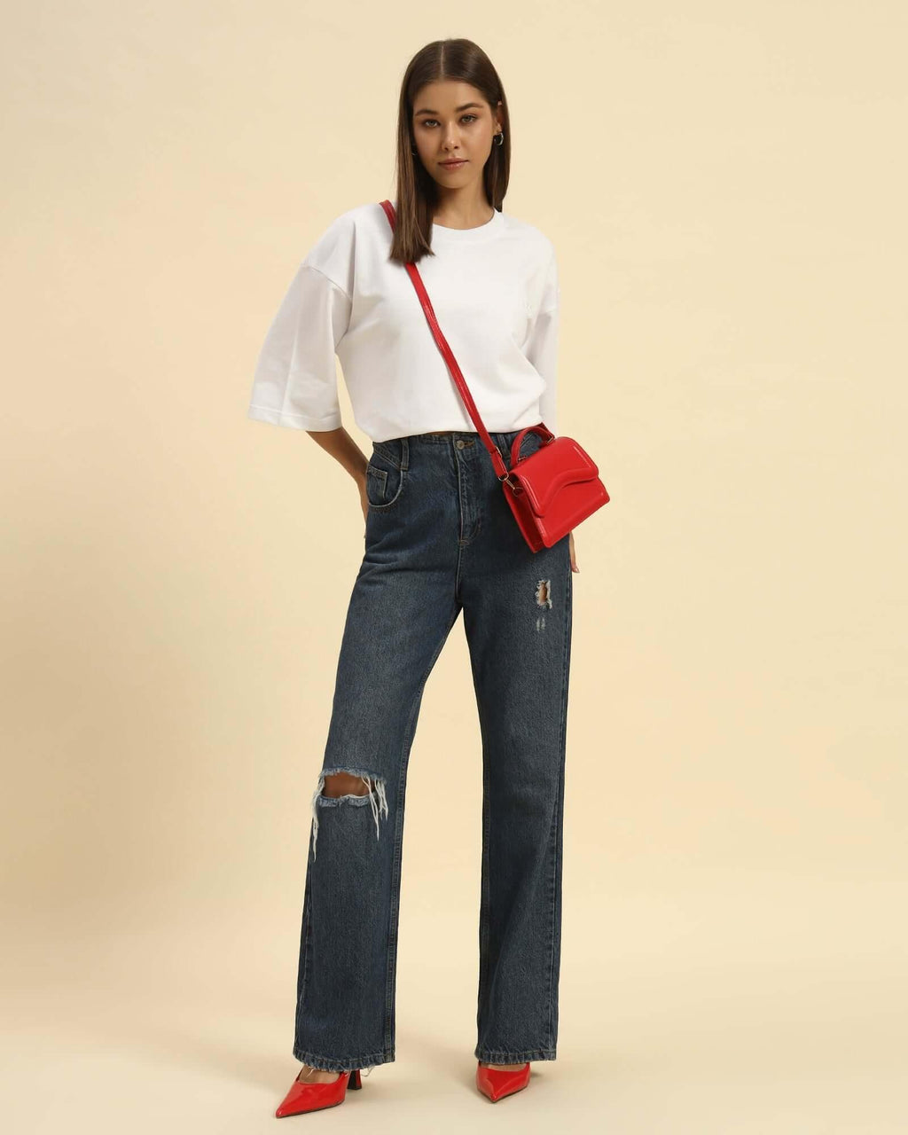 AE Oversized French Terry Crew Neck T-Shirt | White | Woman worn with ripped jeans and a red handbag.