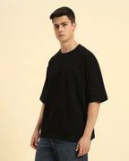 Three-quarter profile of the Men's Black Aeternum French Terry T-Shirt highlighting the heavy-weight cotton drape.