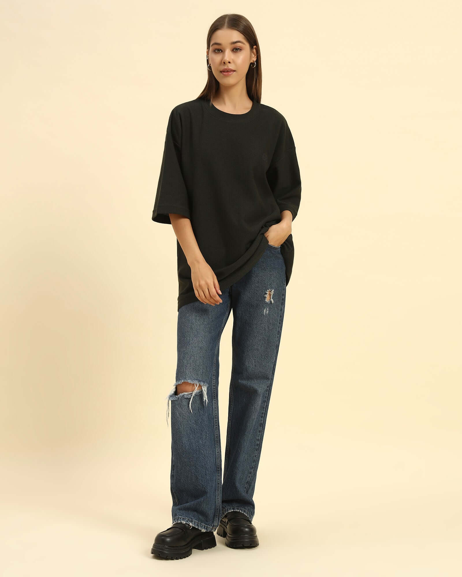 Model wearing the Dark Green Aeternum Jacquard T-Shirt styled with denim jeans - Women's casual oversized streetwear look