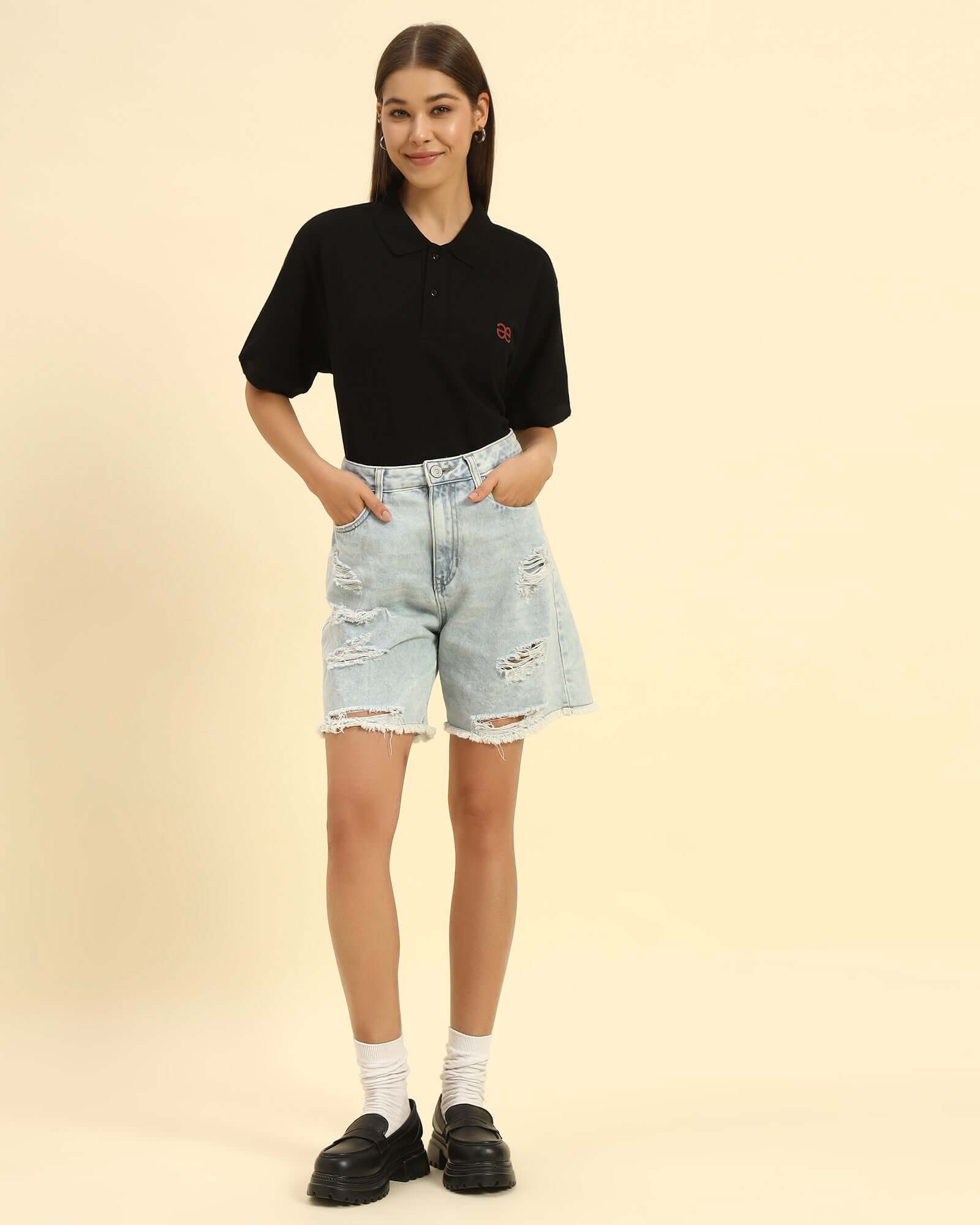 Model wearing the Black Premium Classic Fit Cotton Polo styled with light denim shorts - Women's casual sophisticated look