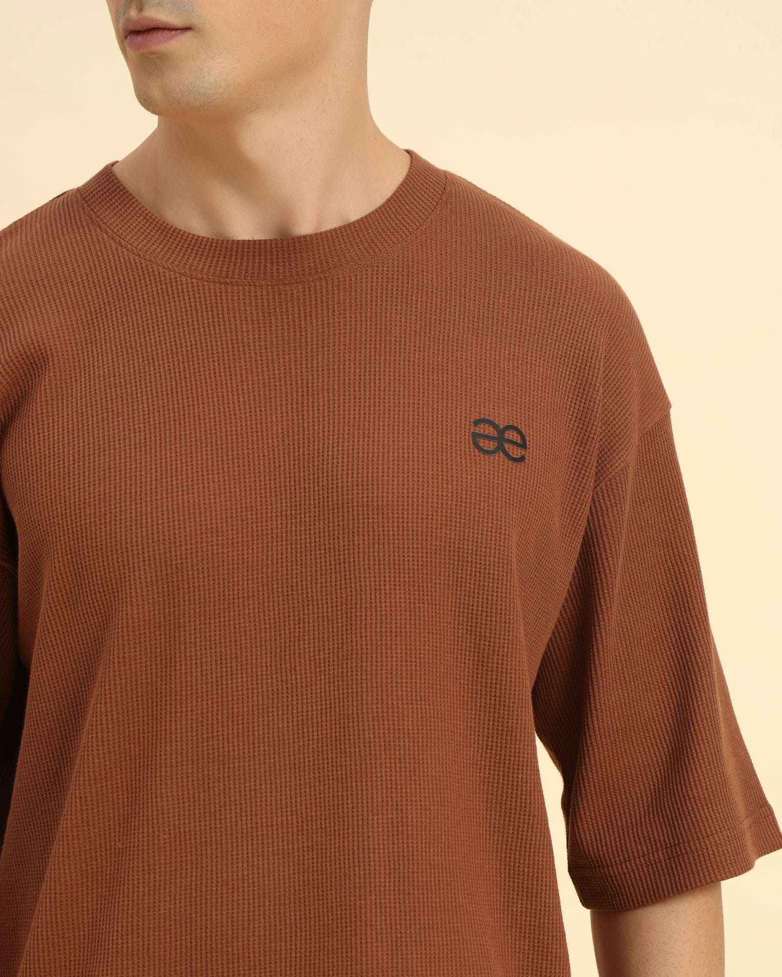 Close-up of the round neckline and intricate waffle knit pattern on the Aeternum Men's Coffee Brown T-Shirt.
