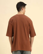 Back view of the Coffee Brown Aeternum Men's Oversized T-Shirt demonstrating the clean, structured silhouette.