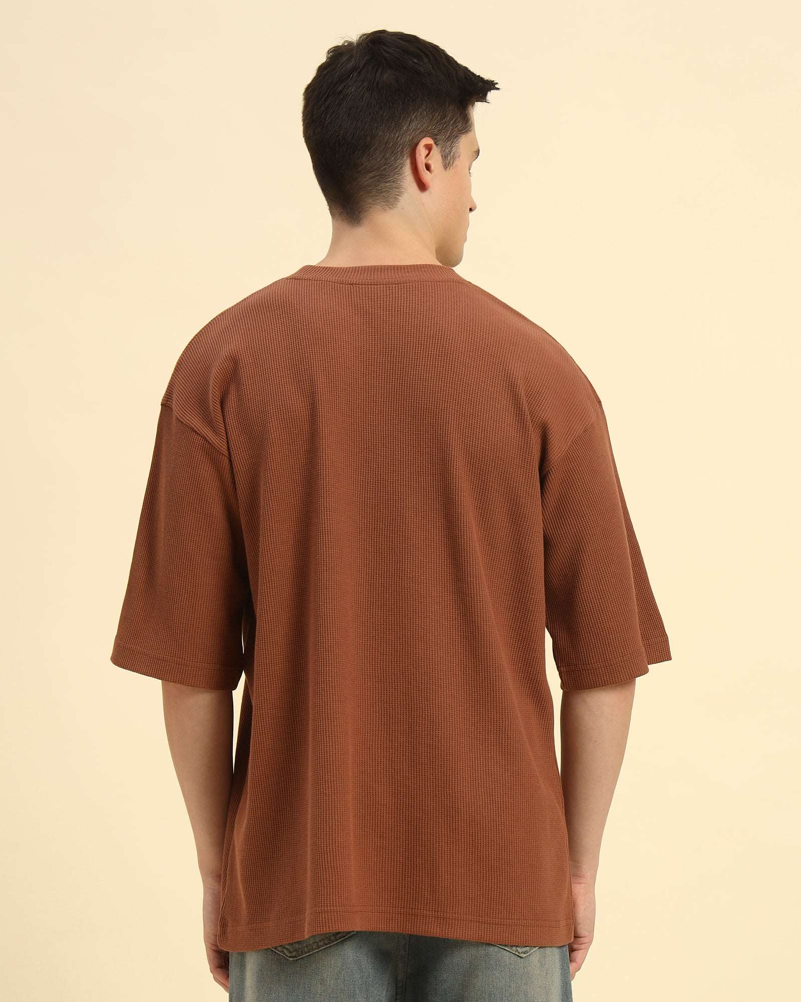 Back view of the Coffee Brown Aeternum Men's Oversized T-Shirt demonstrating the clean, structured silhouette.