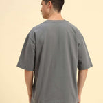Back view of the Dark Grey Aeternum Men's Oversized T-Shirt showcasing the clean shoulder line and comfort-focused cut.