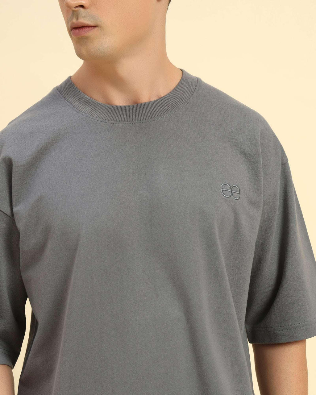 Close-up of the ribbed crew neckline and premium Dark Grey French terry fabric on the Aeternum Men's T-Shirt.