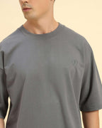 Close-up of the ribbed crew neckline and premium Dark Grey French terry fabric on the Aeternum Men's T-Shirt.