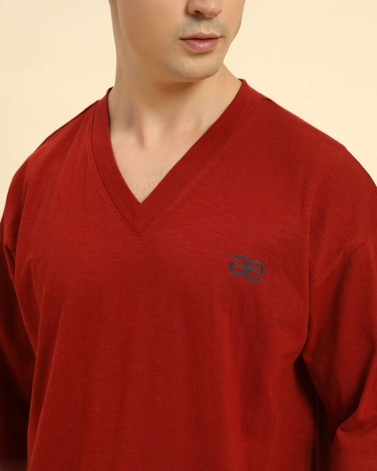 Close-up of the V-neck collar and premium slub knit fabric on the Aeternum Men's Red T-Shirt.