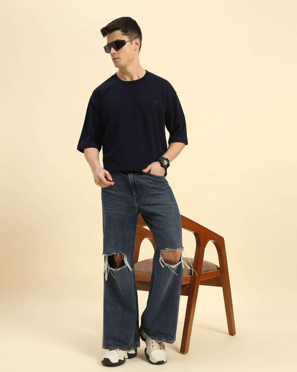 Lifestyle view of the Navy Blue Aeternum French Terry Crew Neck styled with denim while seated, showcasing casual comfort.