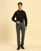 Full body view of the Aeternum Men's Black Giza Cotton Satin Shirt styled with grey trousers for a sophisticated formal look.
