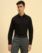 Three-quarter profile of the Men's Black Aeternum Giza Cotton Satin Shirt highlighting the refined tailored fit.